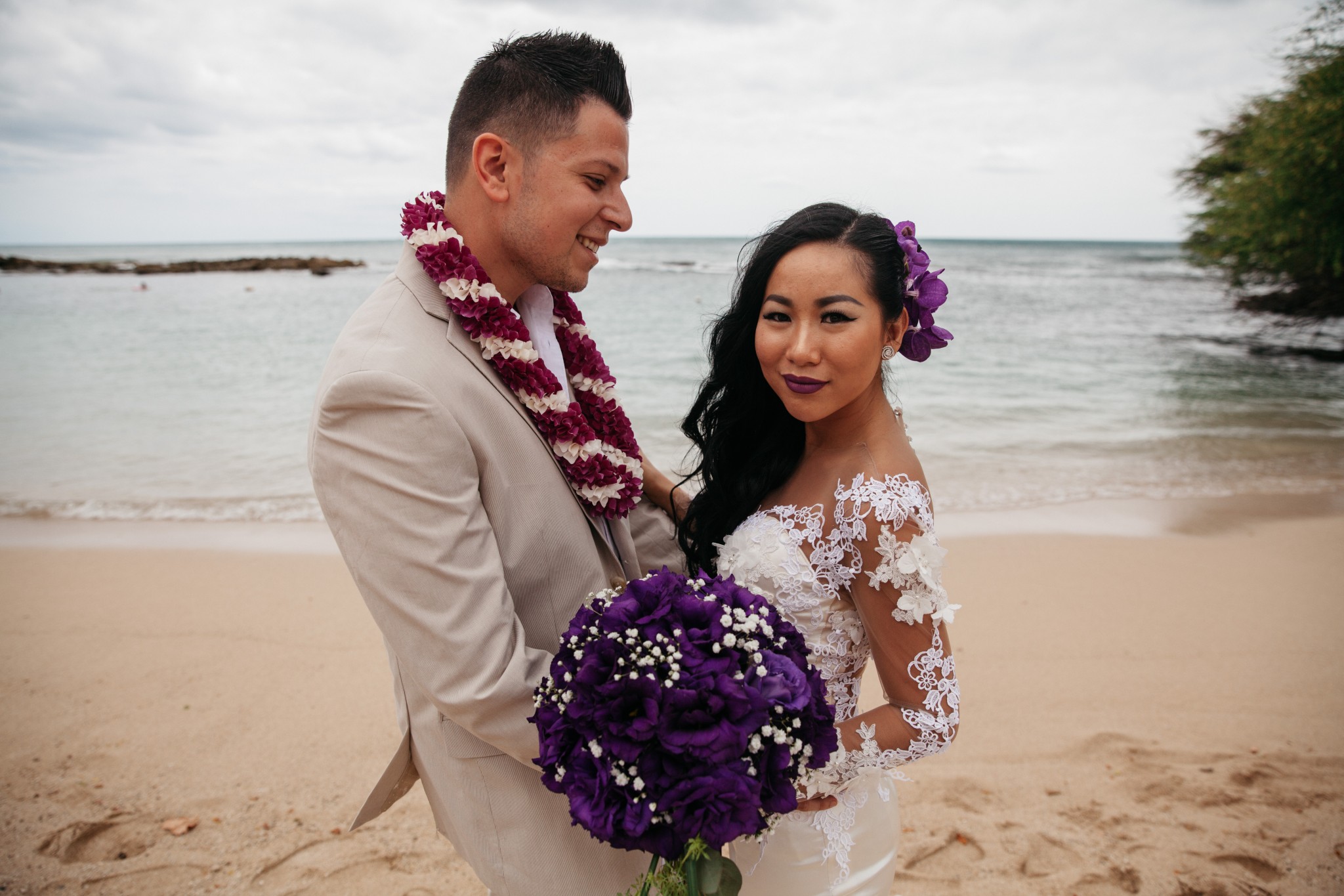 Nhu and her husband standing on a beach together