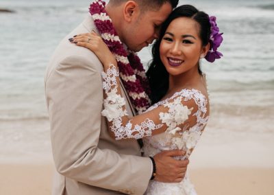 Nhu and her husband hugging on the beach