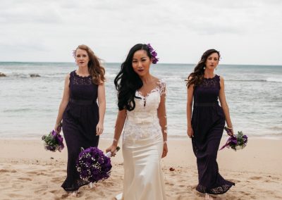 Nhu and her Bridesmaids standing together on the beach