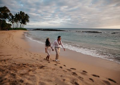 Nhu and her husband walking along a beach