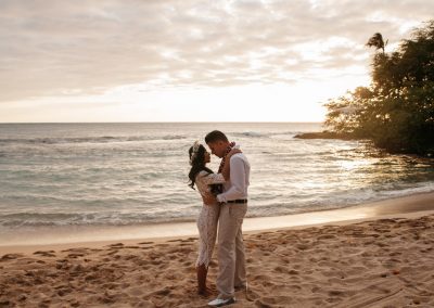 Nhu and her husband standing on a beach together