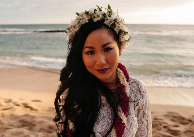 Nhu posing on a beach in her wedding dress