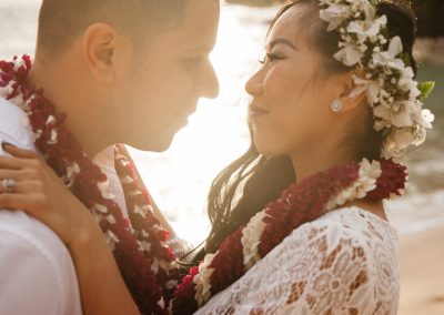 Nhu and her husband posing together in front of a sunset