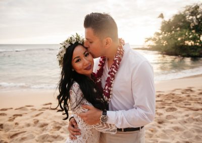 Nhu and her husband posing on a beach together