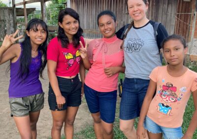 Erica standing with a group of young girls, who are all smiling.
